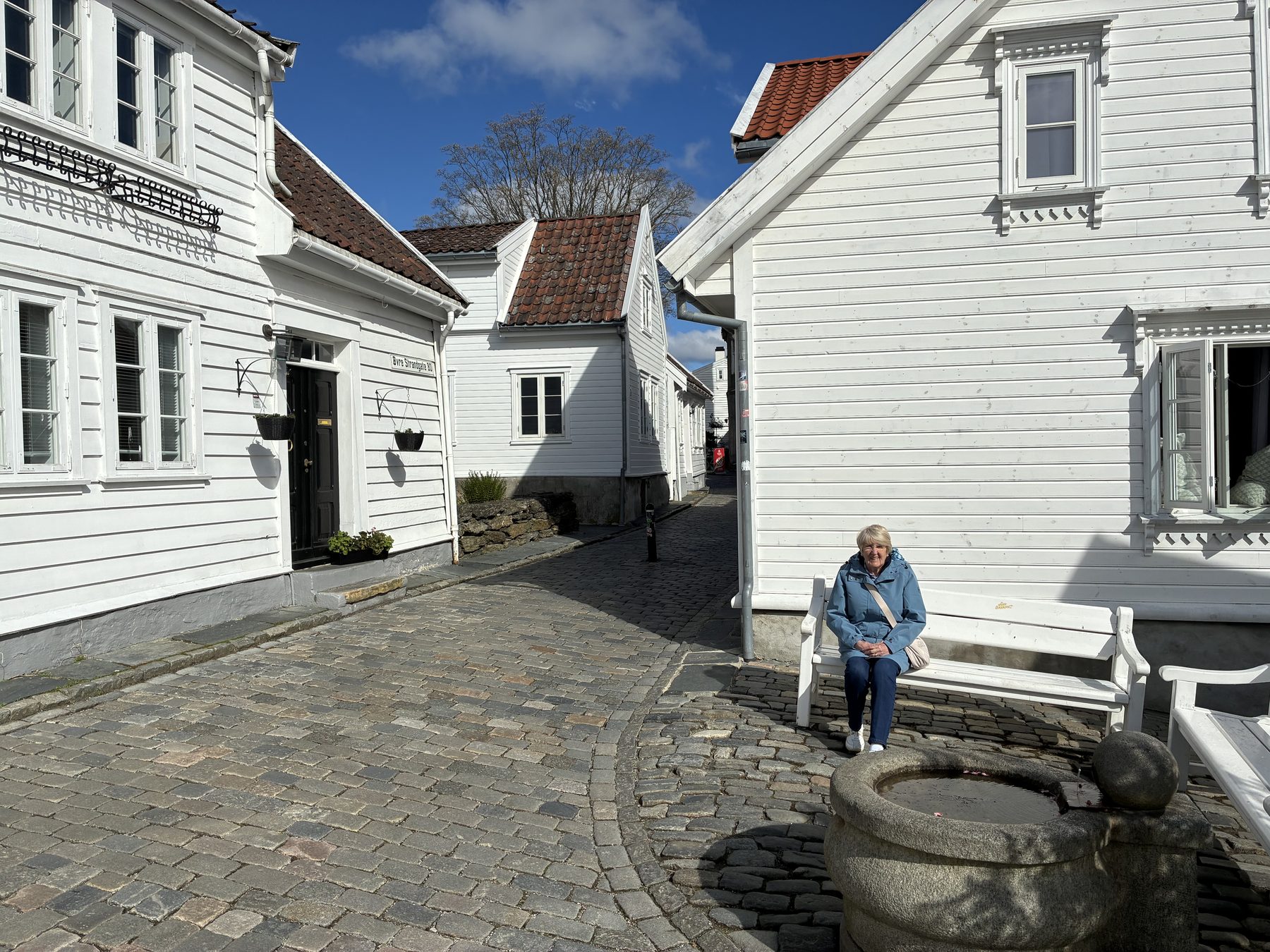 Frances on a white bench in Gamle Stavanger