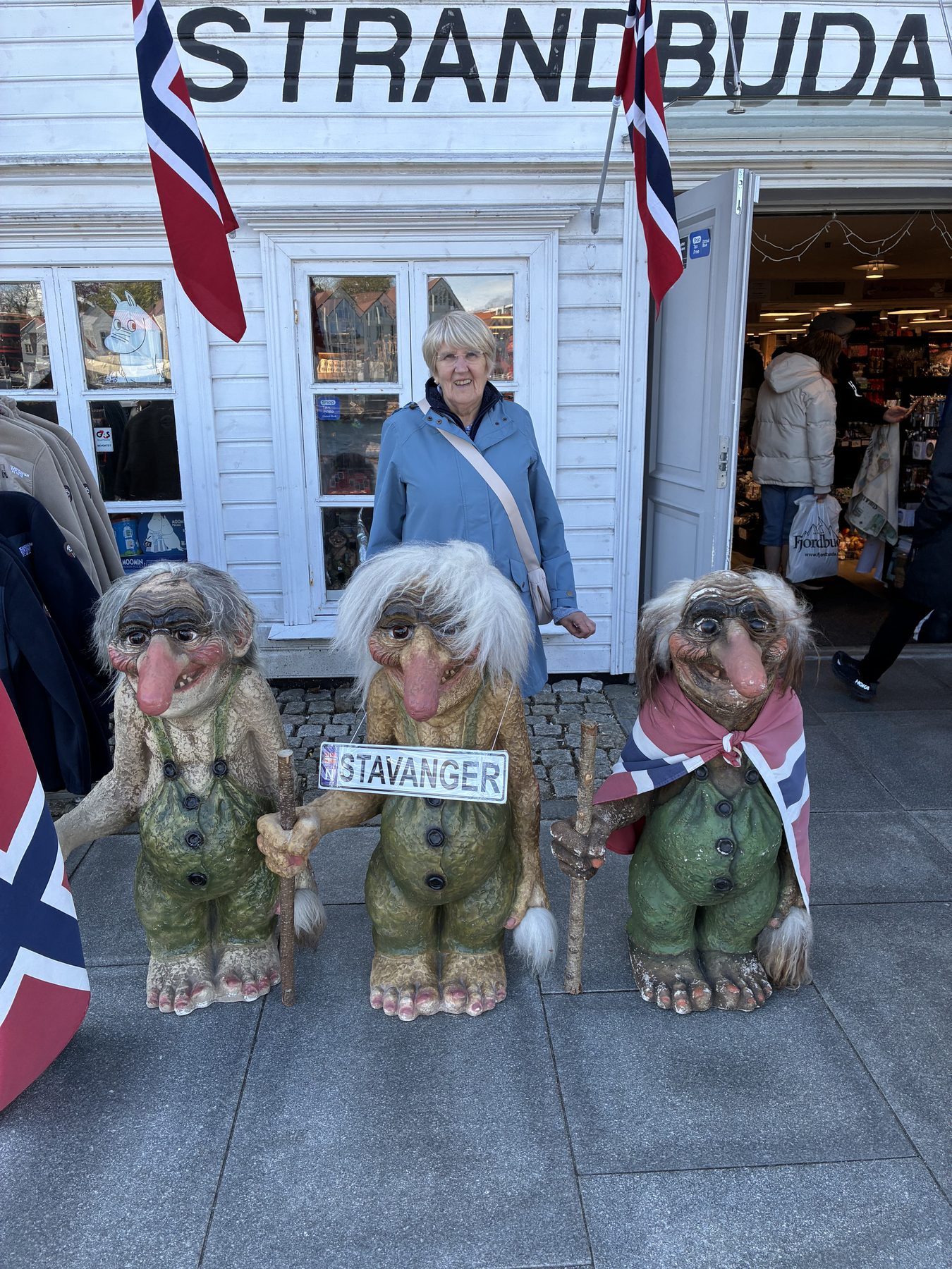 Frances posing with three trolls