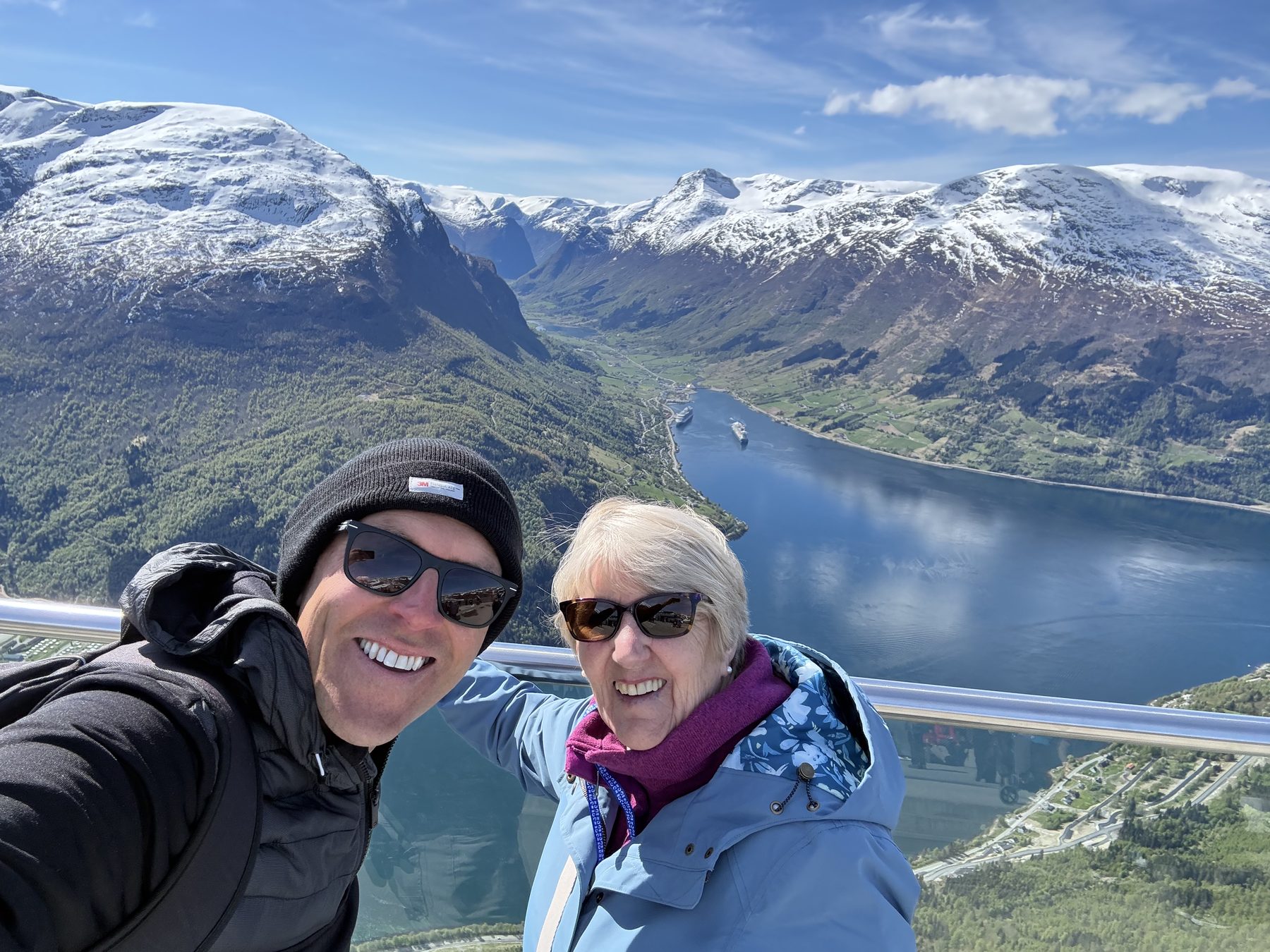 Summit selfie with snow peaks behind