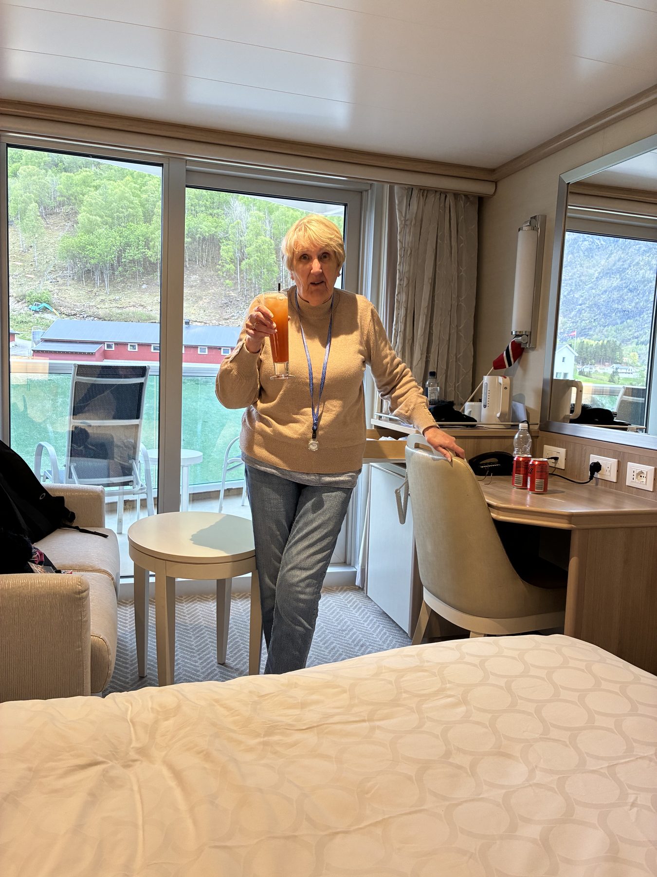 Frances with cocktail in the cabin