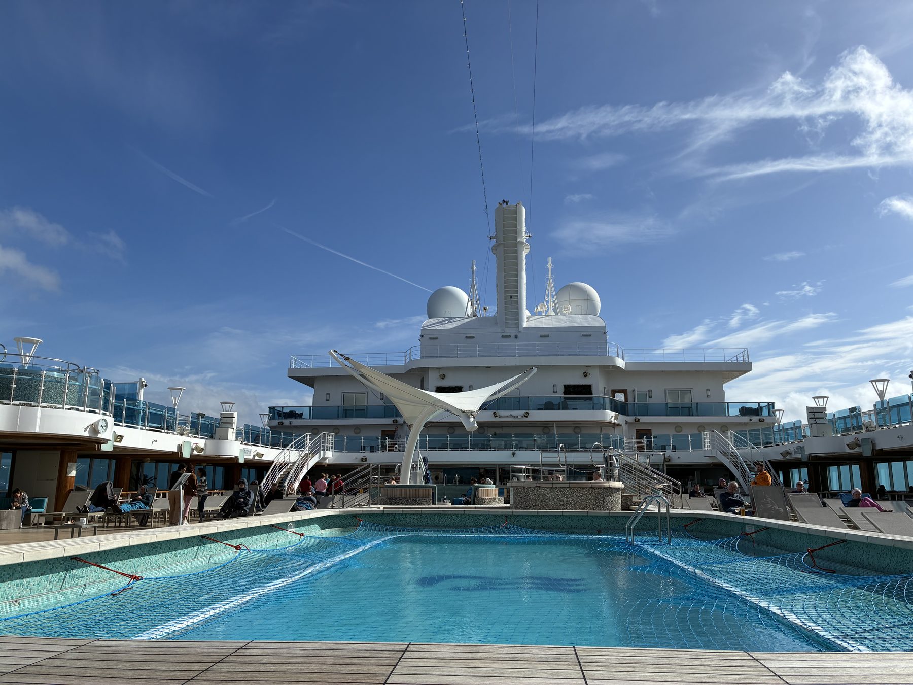 The pool deck under a blue sky on the final sea day