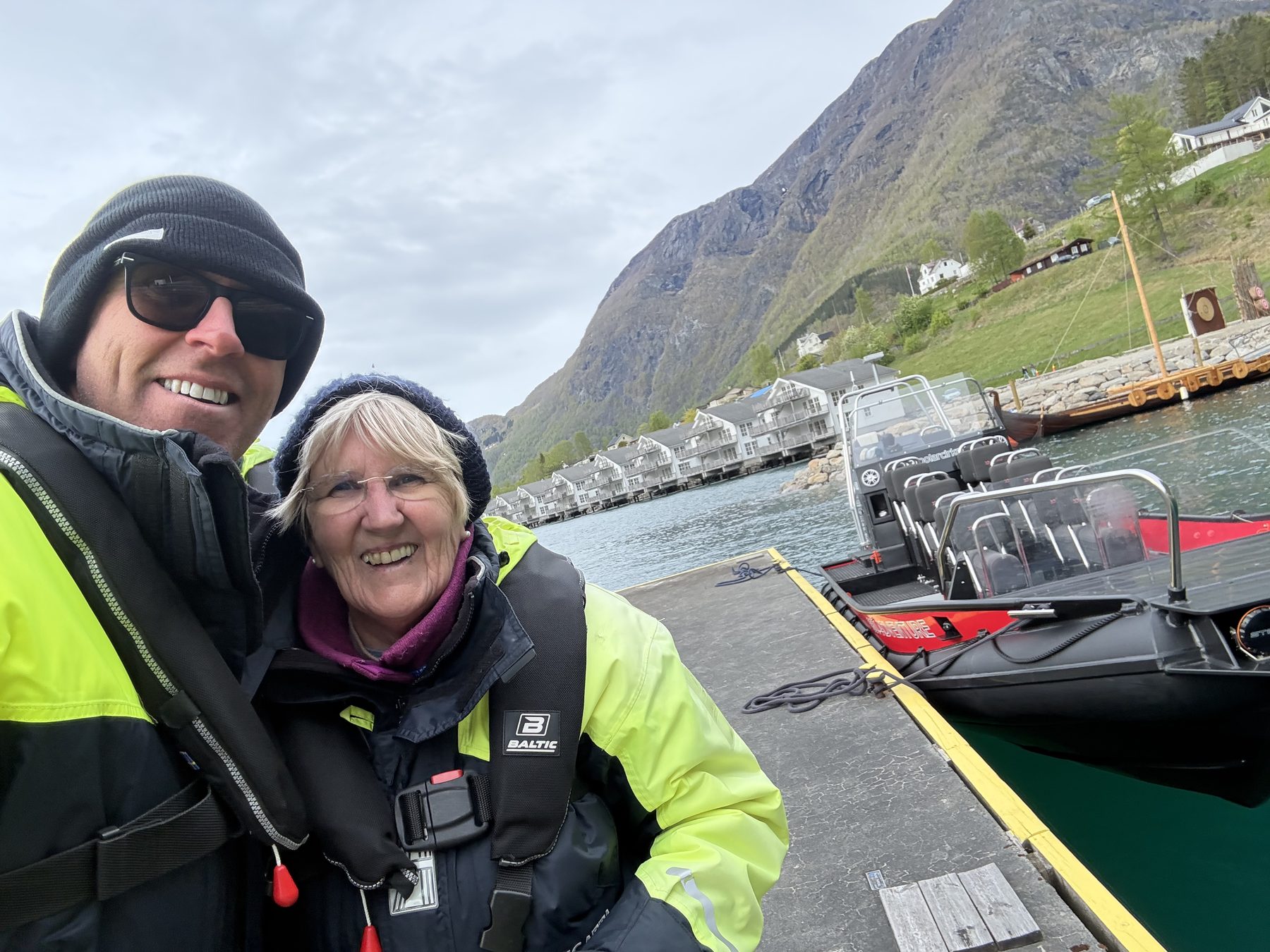 Selfie of Stuart and Frances at the dock with RIB boats moored behind